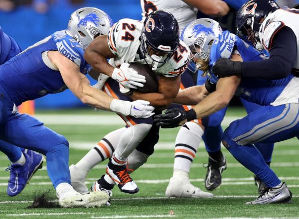 Chicago Bears running back Khalil Herbert tries to break through the Detroit Lions defense in the fourth quarter at Ford Field in Detroit on Nov. 19, 2023.