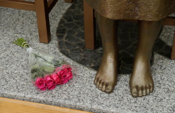 A bouquet lays alongside a statue commemorating Korean "comfort women" at a Sydney church in Sydney