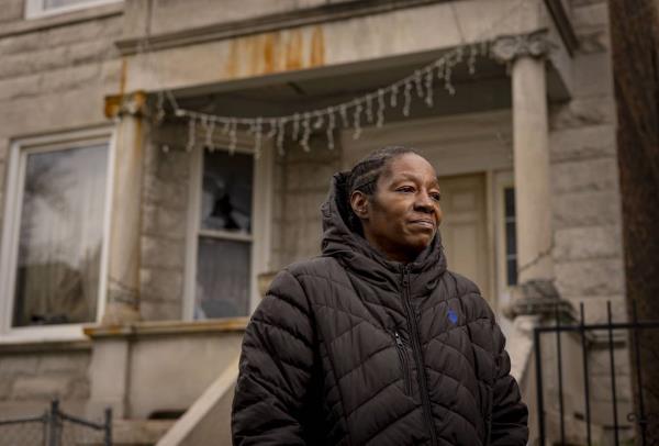Kina Smith stands outside the North Lawndale two-flat owned by her family for decades on Nov. 20, 2023.