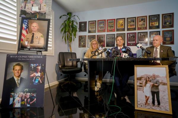 Attorney Bradley Gage, middle, and Kim and Mike Clinkunbroomer, the parents of Deputy Ryan Clinkunbroomer, announce the precursor of a lawsuit against the Sheriff's Department at a news conference.