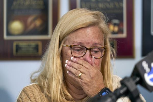 Kim Clinkunbroomer, the mother of late Los Angeles Sheriff's Deputy Ryan Clinkunbroomer, wipes tears as she takes questions from the media after announcing a lawsuit against the Sheriff's Department at a news conference in Los Angeles on Nov. 28, 2023.