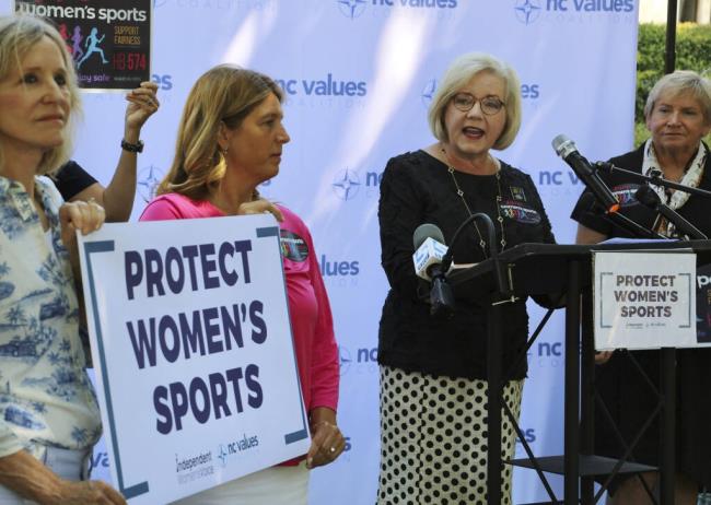 Tami Fitzgerald, center, the executive director of the co<em></em>nservative North Carolina Values Coalition, advocates for a bill banning transgender girls from competing in girls' school sports, Wednesday, Aug. 16, 2023, outside the Legislative Building in Raleigh, N.C. Republican state lawmakers will attempt later Wednesday to override the Democratic governor's veto of the legislation. (AP Photo/Hannah Schoenbaum)