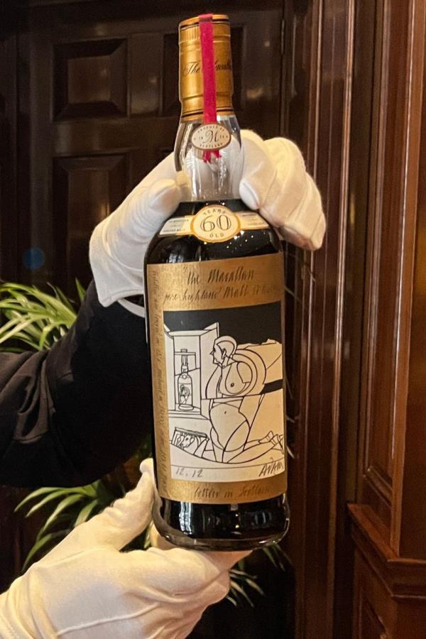 A member of staff shows a bottle of the Macallan Valerio Adami 60 Year Old during a photocall at the auction house Sotheby's in London. — Photo: AFP
