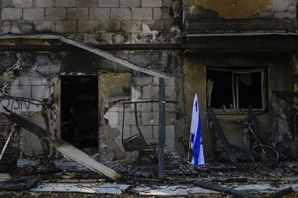 An Israeli flag is placed next to a house destroyed by Hamas militants in Kibbutz Be'eri, Israel, Sunday, Oct. 22, 2023. Picture: AP Photo/Ariel Schalit