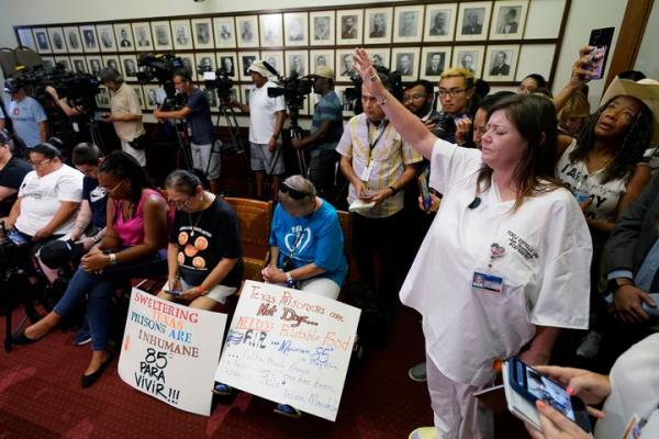 Advocates for cooling Texas prisons pray during a news co<em></em>nference at the Texas Capitol, Tuesday, July 18, 2023, in Austin, Texas. The group is calling for an emergency special session to address the deadly heat effecting inmates. 