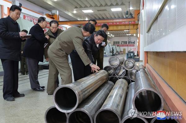 This photo, carried by North Korea's official Korean Central News Agency on Feb. 15, 2024, shows the North's leader Kim Jong-un (R) inspecting a key munitions factory. (For Use o<em></em>nly in the Republic of Korea. No Redistribution) (Yonhap)