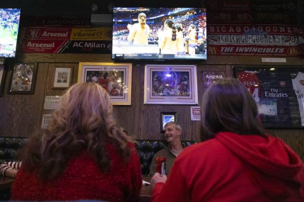 Karen Bunkenburg, left, and Karen Nevotti, right, watch the Nebraska vs. Pittsburgh NCAA women’s volleyball semifinal game at The Globe Pub with friends on Dec. 14, 2023. 