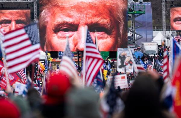 President Do<em></em>nald Trump appears on video screens before his speech to supporters from the Ellipse at the White House in Washington, D.C., on Wednesday, Jan. 6, 2021, as Co<em></em>ngress prepares to certify the electoral college votes.