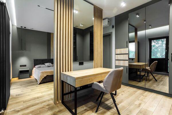  Wooden slats form a bedroom feature set against Gris Verte walls by Colourtrend.