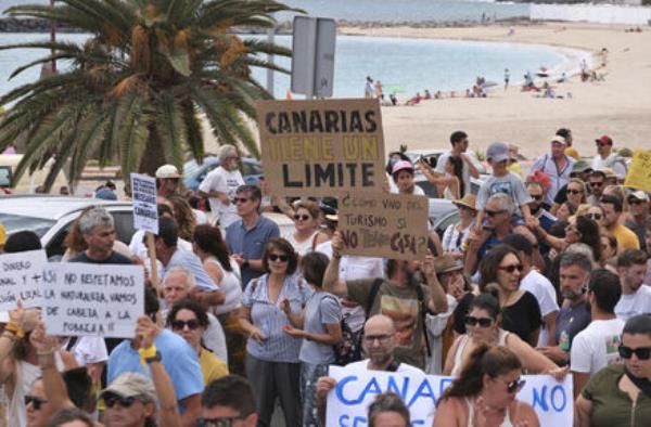 People march past a beach during a demo<em></em>nstration against over tourism which affects the local population with inaccessible housing, among other things, in Puerto del Rosario, Fuerteventura, Spain, Saturday April 20, 2024. Picture: Europa Press via AP People march past a beach during a demo<em></em>nstration against over tourism which affects the local population with inaccessible housing, among other things, in Puerto del Rosario, Fuerteventura, Spain, Saturday April 20, 2024. Picture: Europa Press via AP