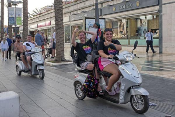 Tourists ride rental scooters in Arona on the Canary island of Tenerife, Spain, Friday, April 19, 2024. Picture: AP Photo/Miguel Velasco Almendral Tourists ride rental scooters in Arona on the Canary island of Tenerife, Spain, Friday, April 19, 2024. Picture: AP Photo/Miguel Velasco Almendral