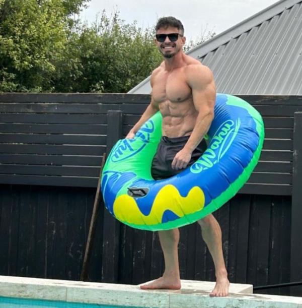 Ty raising the temperature by the pool.