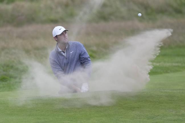 United States' Scottie Scheffler plays a shot from a bunker on the 18th green at went into the hole for a birdie during the second day of the British Open Golf Champio<em></em>nships at the Royal Liverpool Golf Club in Hoylake, England, Friday, July 21, 2023. (AP Photo/Kin Cheung)