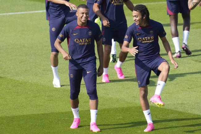 Kylian Mbappe, left, and his brother Ethan Mbappe attend a training session at the new Paris Saint-Germain training center Thursday, July 20, 2023 in Poissy, west of Paris. (AP Photo/Christophe Ena)