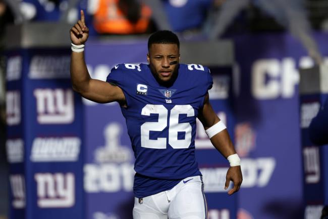 FILE - New York Giants running back Saquon Barkley is introduced before an NFL football game against the Indianapolis Colts, Jan. 1, 2023, in East Rutherford, N.J. Barkley and the Giants failed to reach an agreement on a long-term co<em></em>ntract extension by the Monday, July 17, 2023, deadline for franchised players, leaving the star running back with the option of playing for the tag-mandated $10.1 million salary or maybe taking the season off. (AP Photo/Adam Hunger, File)