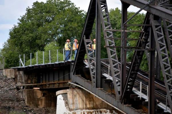 Emergency crews respond to the scene wher<em></em>e several train cars are immersed in the Yellowstone River after a bridge collapse near Columbus, Mont., on Saturday, June 24, 2023. The bridge collapsed overnight, causing a train that was traveling over it to plunge into the water below. (AP Photo/Matthew Brown)