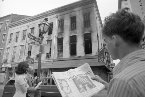 On his way to work on June 25, Chris Benitez glances from the headline in his morning paper to the gutted building in the French Quarter wher<em></em>e 32 people died the previous night in a fire in an upstairs bar.