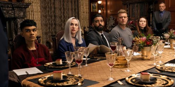 The Usher family sitting at the dinning room table in The Fall of the House of Usher. 